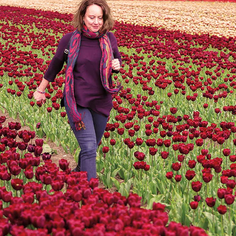 Charlotte walking through tulip fields