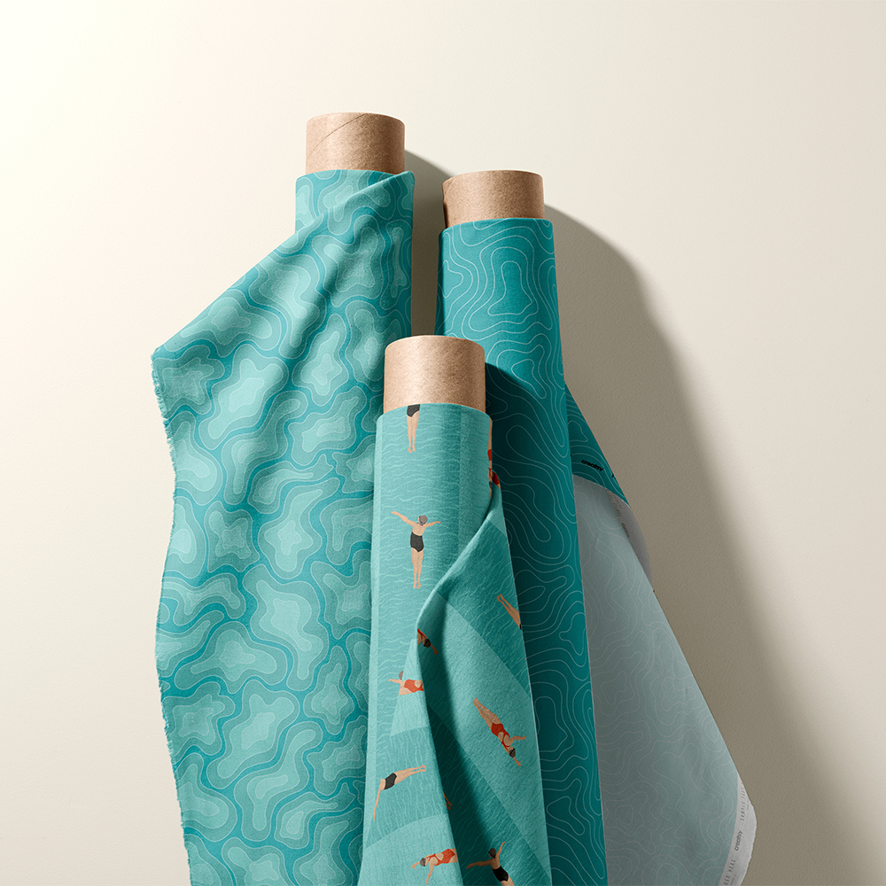 Three upright rolls of fabric from a collection related to swimming and swimming pools. The roll on the left is an aqua fabric called 'Water Camo -Dark'. The middle row has a repeat pattern of women swimmers on a aqua background called 'Lane Swimmers Stripe - Skin Tone 2'. The roll on the right is another abstract aqua repeat pattern called, 'Water Swirl -Dark'